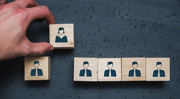Hand selecting a tile with a female image from a row of tiles with male images